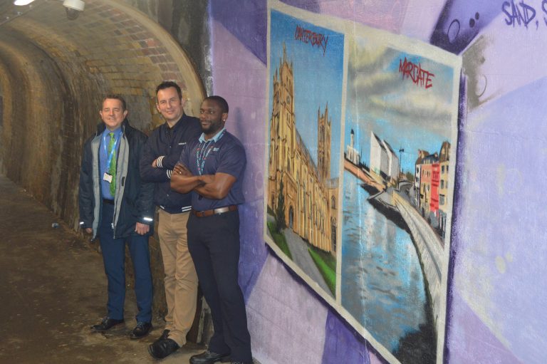 Colourfu mural depicting places that can be visited from Strood station. A cathedral and Chatham Dockside