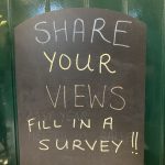 A chalk board "Share Your Views"