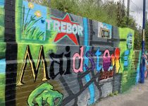 A colourful mural depicting flowers, the Trebor logo, the river Medway and town centre roads, a dinosaur and a bus.