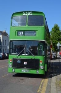 A vintage green double decker bus