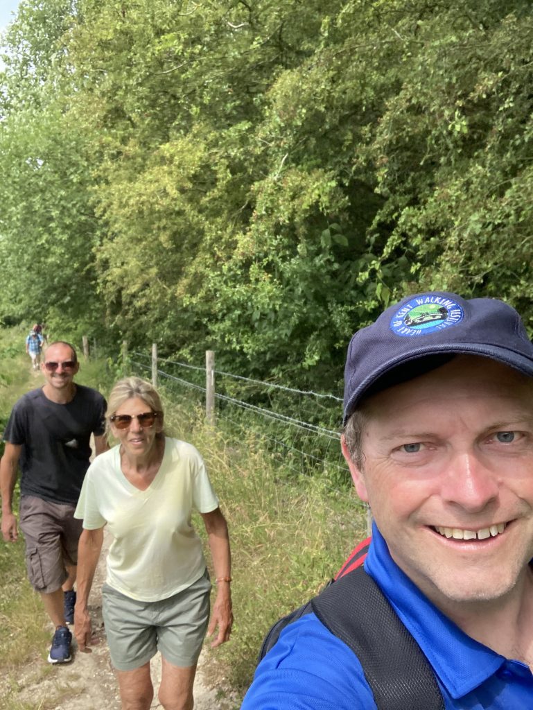 Selfie - Gary and two walkers on a trail beside woodland