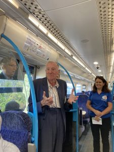 Jonathan delivers a history talk to members on the train
