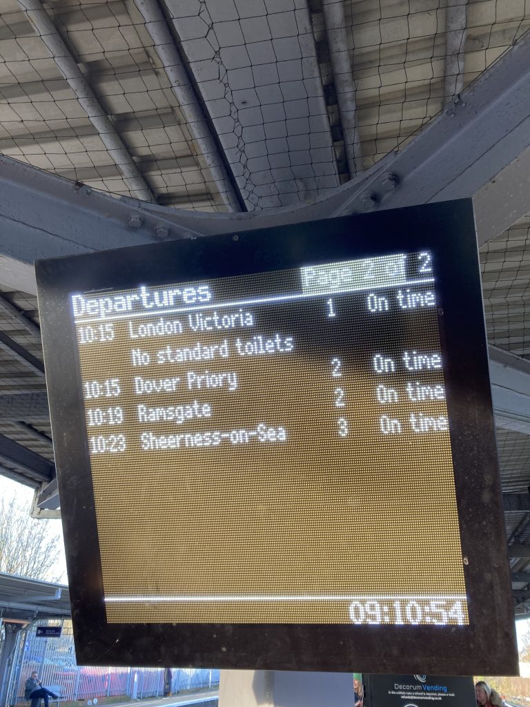 A display board showing information on trains arriving and departing the station.