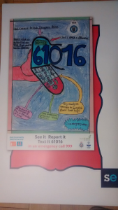 A colourful poster drawn by children to promote British Transport Police 61016 service