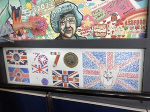 Brightly coloured panels in a variety of designs celebrating the Platinum Jubilee of Queen Elizabeth II