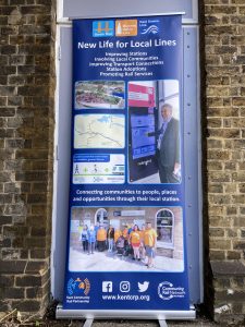 A roller banner display, "New life for local lines"