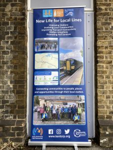 A roller banner display, "New life for local lines"
