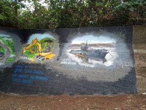 A mural depicting attractions and amenities near Strood station. Diggerland fun park, the Black Widow submarine moored in the River Medway.