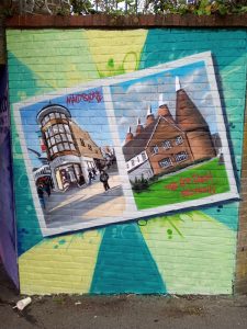 A colourful mural depicting places that can be visited from Strood station. Fremlin Walk shopping arcade in Maidstone and The Hop Farm at Beltring.