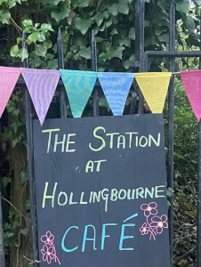 Chalk board and bunting on a railing fence advertising the Station at Hollingbourne Cafe