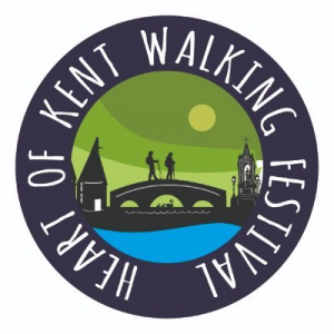 Heart of Kent Walking Festival logo. Circular text, "Heart of Kent Walking Festival" Graphic depicting two people walking across a bridge connecting an Oast House and a Monument.