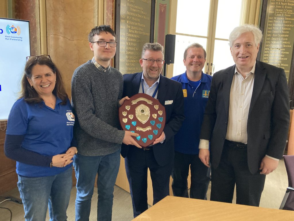 Dominic Noades receives the Mike Fitzgerald shield for Volunteer of the Year 2023/24 Kent Community Rail Partnership. The shield is awarded by Steve White, managing director of Southeastern. Pictured are Therese Hammond, Dominic Noades, Steve White, Gary Outram and Chris Fribbins