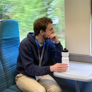 A student on the train gazing out of the window.
