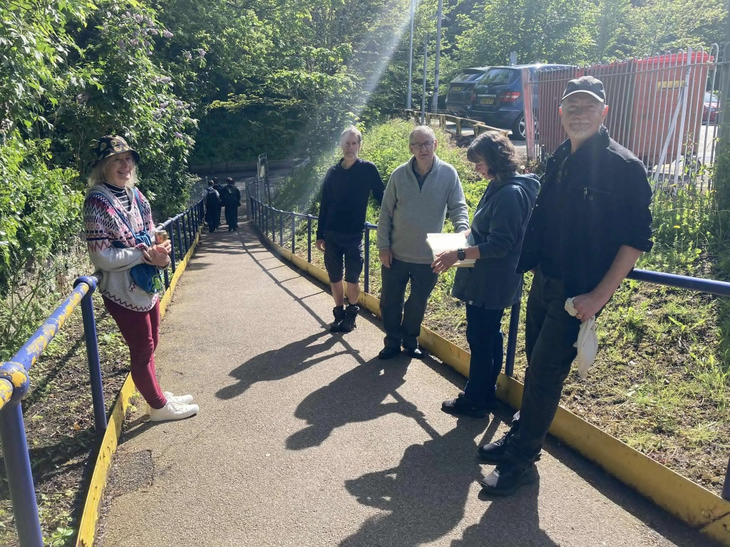 A group of people on a path connecting Bearsted station to a road