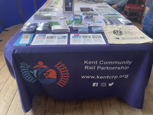 The Kent Community Rail Partnership promotional table, with an assortment of leaflets, brochures and give away items.