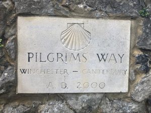 Engraved stone. A scallop shell "Pilgrims Way, Winchester - Canterbury, AD 2000"