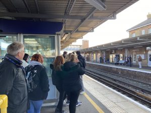 A group of students waiting for a train at Sittingbourne station