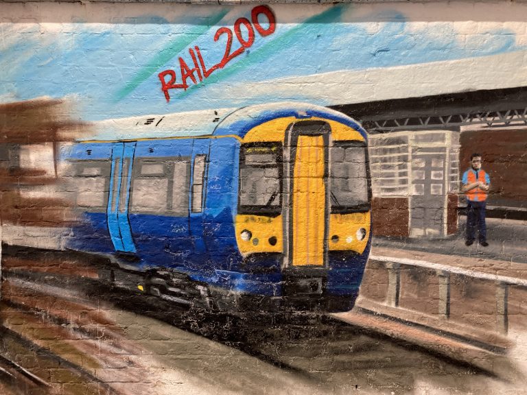 A mural panel painted onto brickwork depicting a modern class 375 electric train at Tonbridge station "Rail 200"