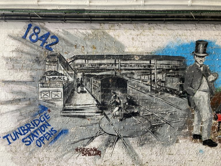 Black and white mural panel depicting Tonbridge station in 1842