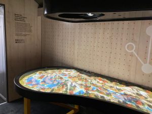 Interior of an Inspiration Train Carriage. An interactive relief map of a railway in a landscape. Trains will stop and start in response to waves of the hand.