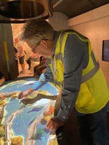 Matthew Fraser demonstrates the interactive relief map aboard Inspiration.