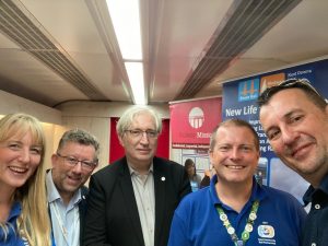 Vicky, Steve White (Managing Director, South Eastern Railway), Chris Fribbins, Gary and Graham Upton (Street artist) pose together for a picture onboard Inspiration