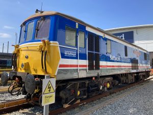 A diesel locomotive, "Kent and East Sussex Railway" in Network South East red white and blue "toothpaste" livery.