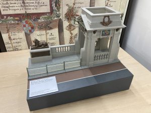 Model of one of the abutments of Rochester bridge. A bronze lion on a plinth. stone ballustrades and ornate gateway