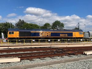 A diesel locomotive from Great Britain Rail freight, "GBRf 66315" parked in sidings