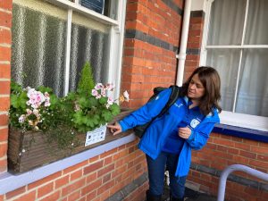 Therese shows off the flowers in the station adopter's windowboxes at Charing