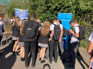 A crowd of students at the display stands