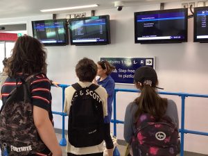 Therese explains the information screens to Students at Maidstone East station