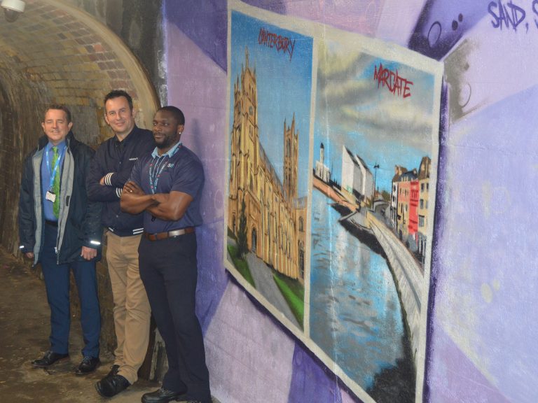 Colourfu mural depicting places that can be visited from Strood station. Canterbury Cathedral and Margate sea front