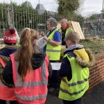 Cub Leader Antonia Boorman explains to the Cubs the design of the bug hotel and talks through the instruction guide.