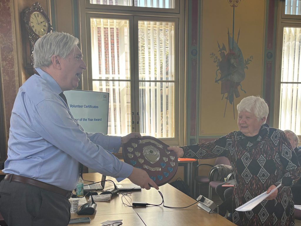 Linda Brinklow receives the volunteer of the year award from Chris Fribbins