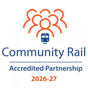 Logo. Stylised outlines of heads and shoulders of a group of people coloured in orange above a train coloured blue. Community Rail Accreited Partnership 2026-27