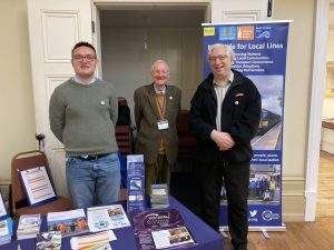 Dominic, Jonathan and Chris at our promotional stall, a variety of leaflets and brochures spread out on the table.