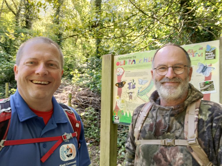 Gary and Kevin pose for a selfie in front of an information panel for Old Park Hill reserve