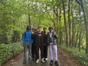 Students walking along a quiet tree-lined road
