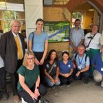 A group of people pose in front of the new information panel at Hollingbourne station. Matt, Clive, jenny, rebecca, Sarah, Therese, Paul, Colin, Kimmy, Gary, Denis