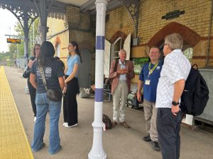 A group of people wait for their train at Hollingbourne station