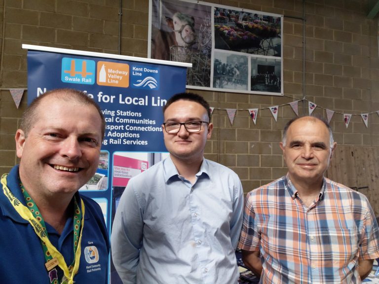 Selfie of Cary, Dominic and Chris in front of a Kent CRP promotional roller banner.